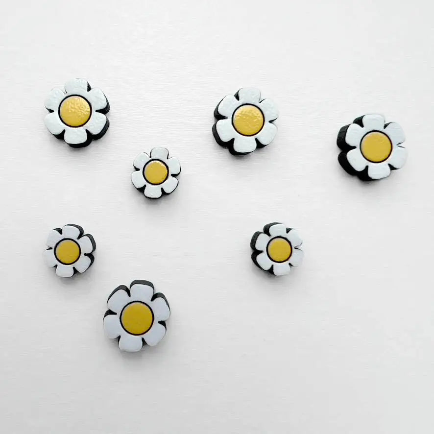 Adorable daisy flower wood stud earrings with titanium posts. Perfect for adding a cheerful, boho, or retro touch to any outfit.