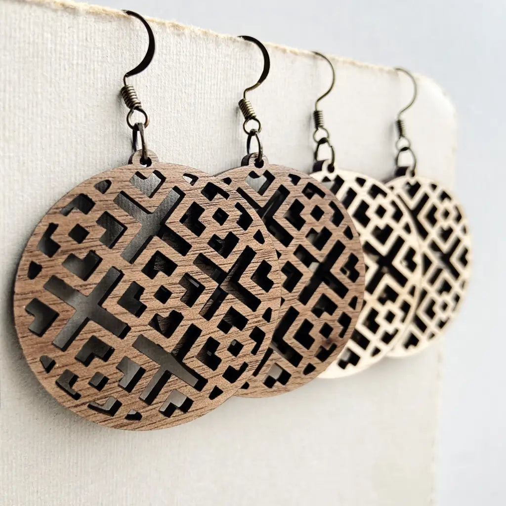 Boho geometric earrings with intricate laser-cut designs in walnut and maple. Perfect for modern, rustic, or casual looks. Lightweight, stylish, and versatile