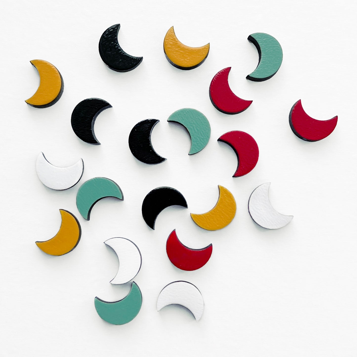 Handmade wood earring in the shape of a crescent moon. Hand painted. Hypoallergenic titanium posts