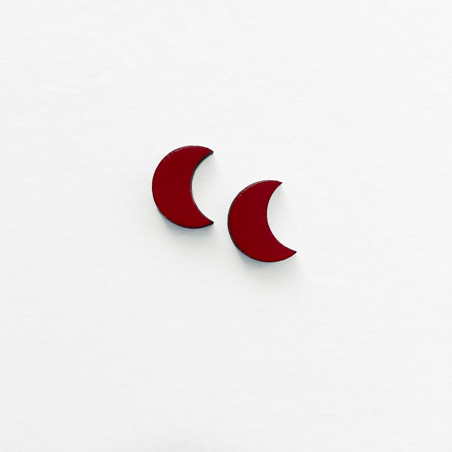 Handmade wood earring in the shape of a crescent moon. Hand painted. Hypoallergenic titanium posts. Red Crescent Moon