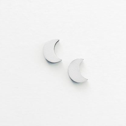 Handmade wood earring in the shape of a crescent moon. Hand painted. Hypoallergenic titanium posts. White Crescent Moon